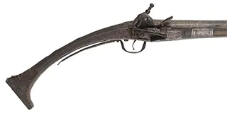 Antique Miquelet Musket, 
.60 caliber smoothbore, 54-1/2" barrel,
Miquelet flintlock, engraved steel & brass trim